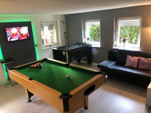 a living room with a pool table and a couch at Ferienwohnung Lindlar in Lindlar