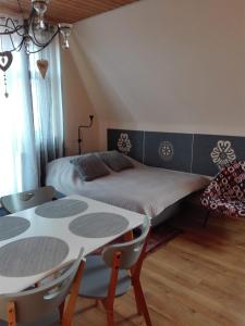 1 dormitorio con 1 cama, mesa y sillas en Pokoje Jola Zakopane, en Zakopane