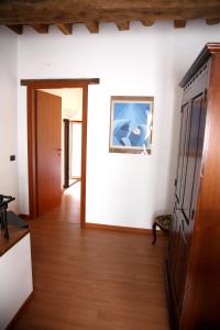 a hallway with a door to a room with white walls at B&B Stradivari in Cremona