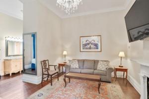a living room with a couch and a fireplace at Andrew Jackson Hotel French Quarter in New Orleans