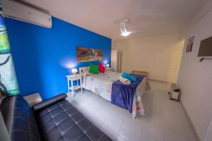 1 dormitorio con cama y pared azul en Casa Camino al Castillo, en Xàtiva