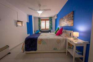 a bedroom with a bed and a table and a window at Casa Camino al Castillo in Xàtiva