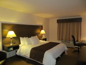 Voodi või voodid majutusasutuse Villegiature Deux Rivieres Resort toas
