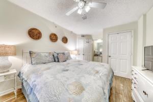 a bedroom with a bed and a ceiling fan at Royal Palms #1006 in Gulf Shores