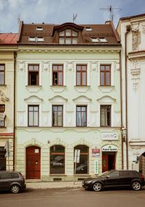 a large building with cars parked in front of it at Mid Apart Mennicza Cieszyn in Cieszyn