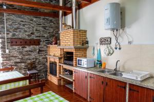 a kitchen with a sink and a counter top at Casa da Passagem in Vila Real