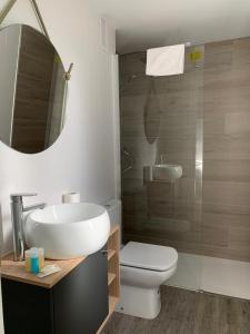 a bathroom with a sink and a toilet and a mirror at Ciudad de Jaca in Jaca