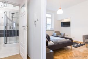 a bedroom with a king sized bed and a bathroom at Mid Apart Mennicza Cieszyn in Cieszyn