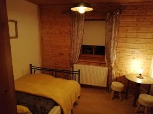 a bedroom with a bed and a table and a window at Rad - Wanderparadis Tiroler Zugspitze Arena Biberwier in Biberwier