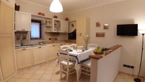 a kitchen with a table and chairs in a kitchen at Casa Leuca ALBENGA in Albenga
