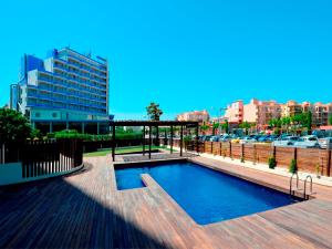 a swimming pool in a city with a building at Apart-rent Apartment Cristall Mar 2º 0058 in Empuriabrava