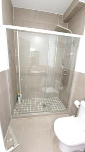 a bathroom with a shower with a toilet and a sink at Fantástico apartamento, cerca de todo, para disfrutar de la ciudad in A Coruña +49 photos