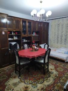 a dining room with a red table and chairs at Apartment Ljupka in Pančevo