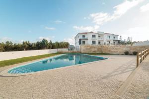 a swimming pool in front of a house at Palhanas - Holiday Homes - By SCH in Salir de Porto