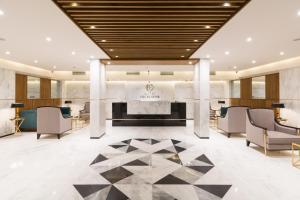 a lobby of a hotel with a fireplace at Hotel Excelsior Karachi in Karachi