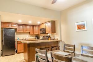 a kitchen with wooden cabinets and a table and chairs at Mountain Ridge Cabins & Lodging Between Bryce and Zion National Park in Hatch