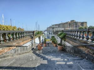 a row of potted plants on a wall with a harbor at RESIDENZA SANTA LUCIA in Naples