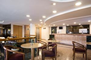 a restaurant with tables and chairs and a bar at Days Inn by Wyndham Montevideo in Montevideo