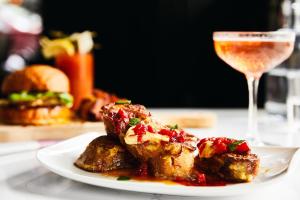 a plate of food and a glass of wine at Kimpton Hotel Vintage Portland, an IHG Hotel in Portland