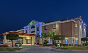 a rendering of a hotel at night at Holiday Inn Express & Suites Houston East, an IHG Hotel in Houston