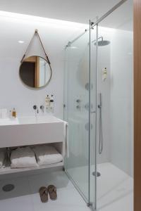a bathroom with a glass shower and a sink at Aroeira Lisbon Hotel - Sea & Golf in Aroeira