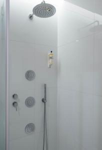 a shower with a glass door in a bathroom at Aroeira Lisbon Hotel - Sea & Golf in Aroeira