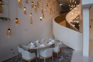 a dining room with a table and chairs and a staircase at Aroeira Lisbon Hotel - Sea & Golf in Aroeira