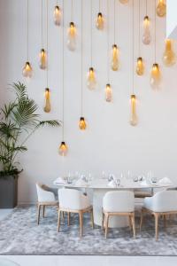 a dining room with a table and chairs and lights at Aroeira Lisbon Hotel - Sea & Golf in Aroeira