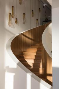 a staircase in a house with wooden floors and lights at Aroeira Lisbon Hotel - Sea & Golf in Aroeira