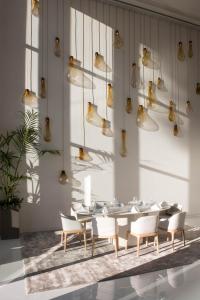 a dining room with a table and chairs and lights at Aroeira Lisbon Hotel - Sea & Golf in Aroeira