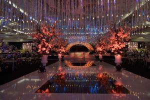a large banquet hall with a large chandelier and flowers at Kempinski Palace Cairo in Cairo +131 photos