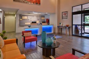 a living room with a couch and a table at Holiday Inn Express & Suites Austin North Central, an IHG Hotel in Austin