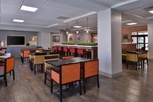 a dining room with tables and chairs and a tv at Holiday Inn Express & Suites Austin North Central, an IHG Hotel in Austin