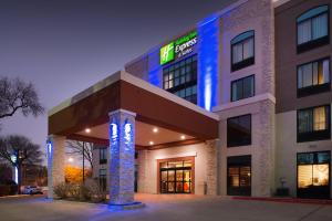a hotel with a lit up building at night at Holiday Inn Express & Suites Austin North Central, an IHG Hotel in Austin