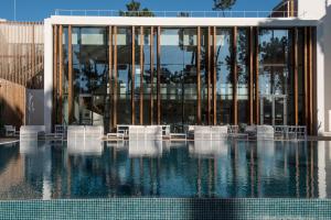 a building with a pool of water in front of it at Aroeira Lisbon Hotel - Sea & Golf in Aroeira