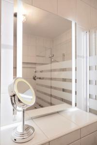 a white bathroom with a mirror and a shower at City Flair in Dresden +32 photos