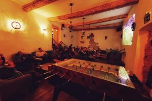a group of people sitting in a room at The Monks Bunk Hostel & Bar in Tallinn