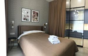 a bedroom with a bed with towels on it at *Luxury apartment in the city center* in Kyiv