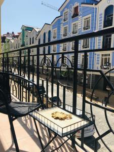 a table and chairs on a balcony with buildings at *Luxury apartment in the city center* in Kyiv