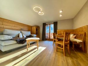 a living room with a couch and a table at Gästehaus Edlhuber in Mittenwald +51 photos