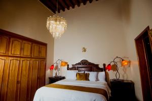 Ліжко або ліжка в номері Hotel Posada San Miguel