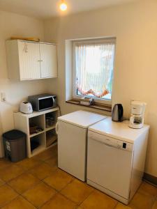 a kitchen with a white refrigerator and a window at Ferienhaus Jehle Friedrichshafen in Friedrichshafen