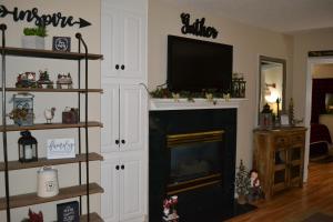 a living room with a fireplace with a flat screen tv at River Place Condos #407 2BD in Pigeon Forge