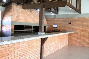 a brick counter in a room with a brick wall at Pousada ACM Tramandaí - RS in Tramandaí