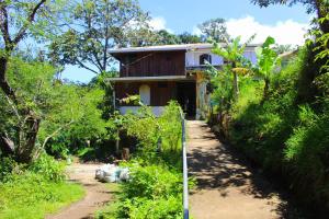 a house in the middle of a dirt road at Casa Alquimia in Monteverde Costa Rica