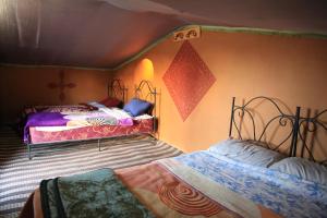 a bedroom with two beds in a room at Camp desert nomad tour in Mhamid