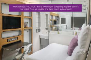 a hospital room with a bed and a tv at YOTELAIR Amsterdam Schiphol Transit Hotel in Schiphol