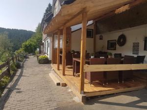 a building with a restaurant with tables and chairs at Landgasthof Nesselbach in Schmallenberg