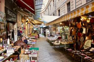 a market with people sitting at tables in a street at VUCCIRIA 57 locazione turistica nel cuore pulsante della movida! in Palermo