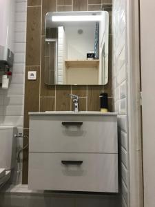 a bathroom with a white sink and a mirror at AlloAppartMeublé_L'écrin in Houilles +25 photos